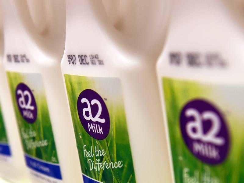 Bottles of A2 milk are displayed in a fridge