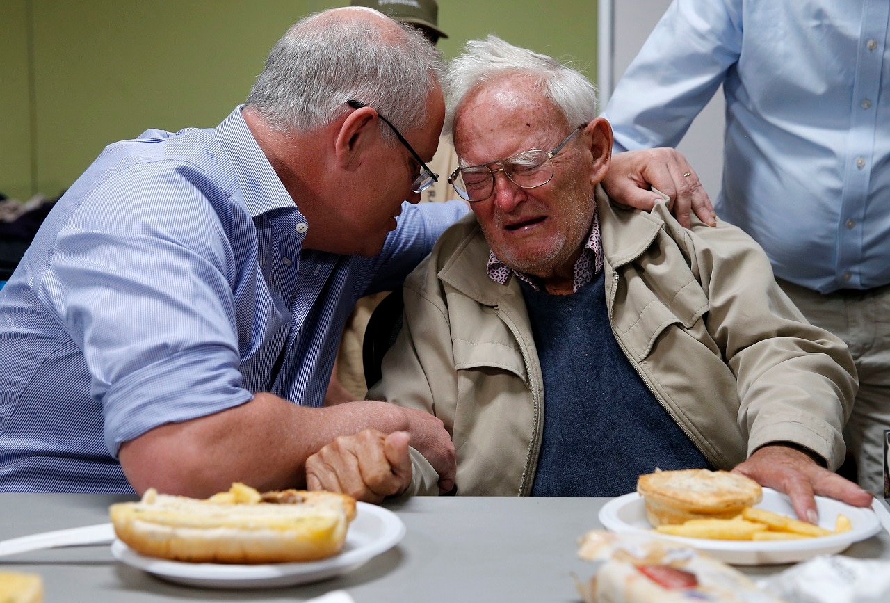 Prime Minister Scott Morrison is seen comforting 85 year old Owen Whalan of Koorainghat.
Prime Minister Scott Morrison is seen comforting 85 year old Owen Whalan of Koorainghat.