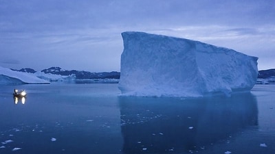 Boat navigated icebergs in eastern Greenland.