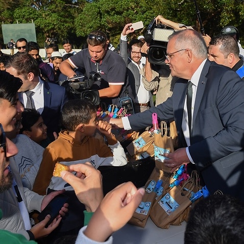 PM Scott Morrison hands out lolly bags after Eid prayers, the end of Muslim Ramadan on Day 2 of the 2022 federal election campaign, at Parramatta Park in Sydney