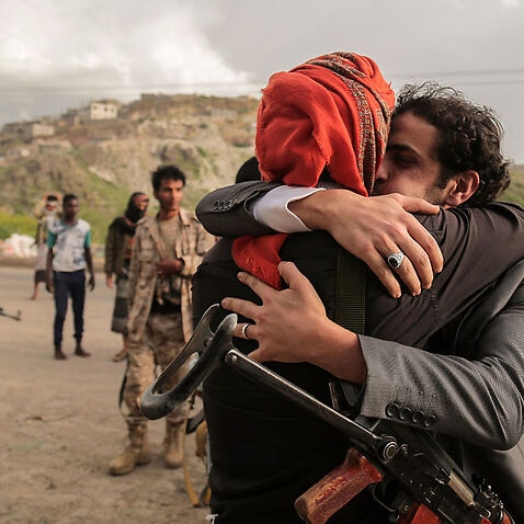 A Yemeni tribesman supporting President Hadi is greeted by a comrade with an emotional hug after his release as part of a prisoner exchange.
