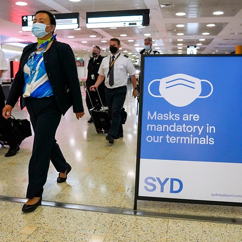 A flight crew walk through the terminal at Sydney Airport 