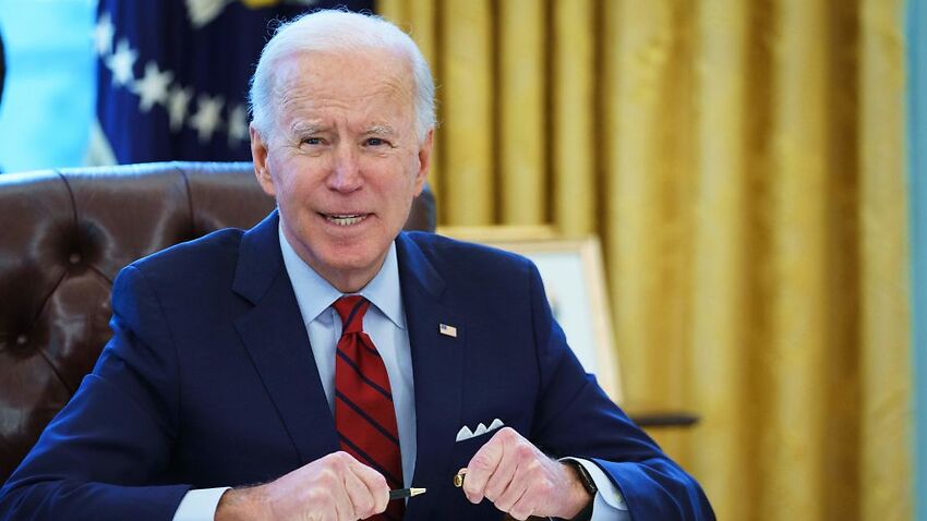 US President Joe Biden prepares to sign  executive orders on healthcare in the Oval Office of the White House on 28 January 2021.
