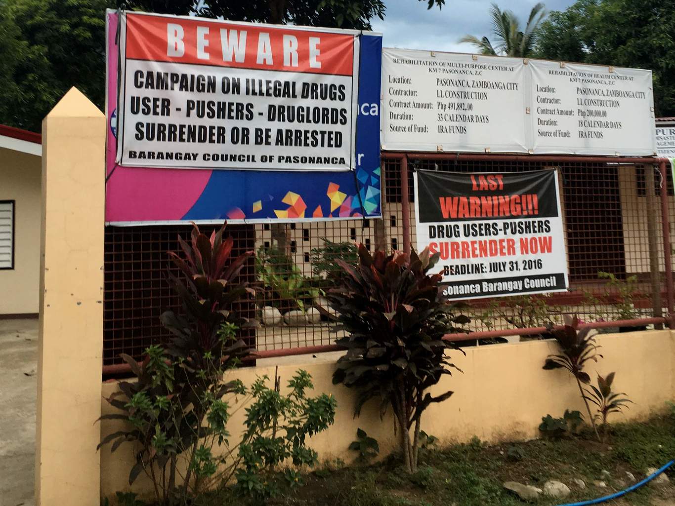 In a village center in Zamboanga City, posters call on drug users to surrender or face the consequences. In a village center in Zamboanga City, posters call on drug users to surrender or face the consequences.