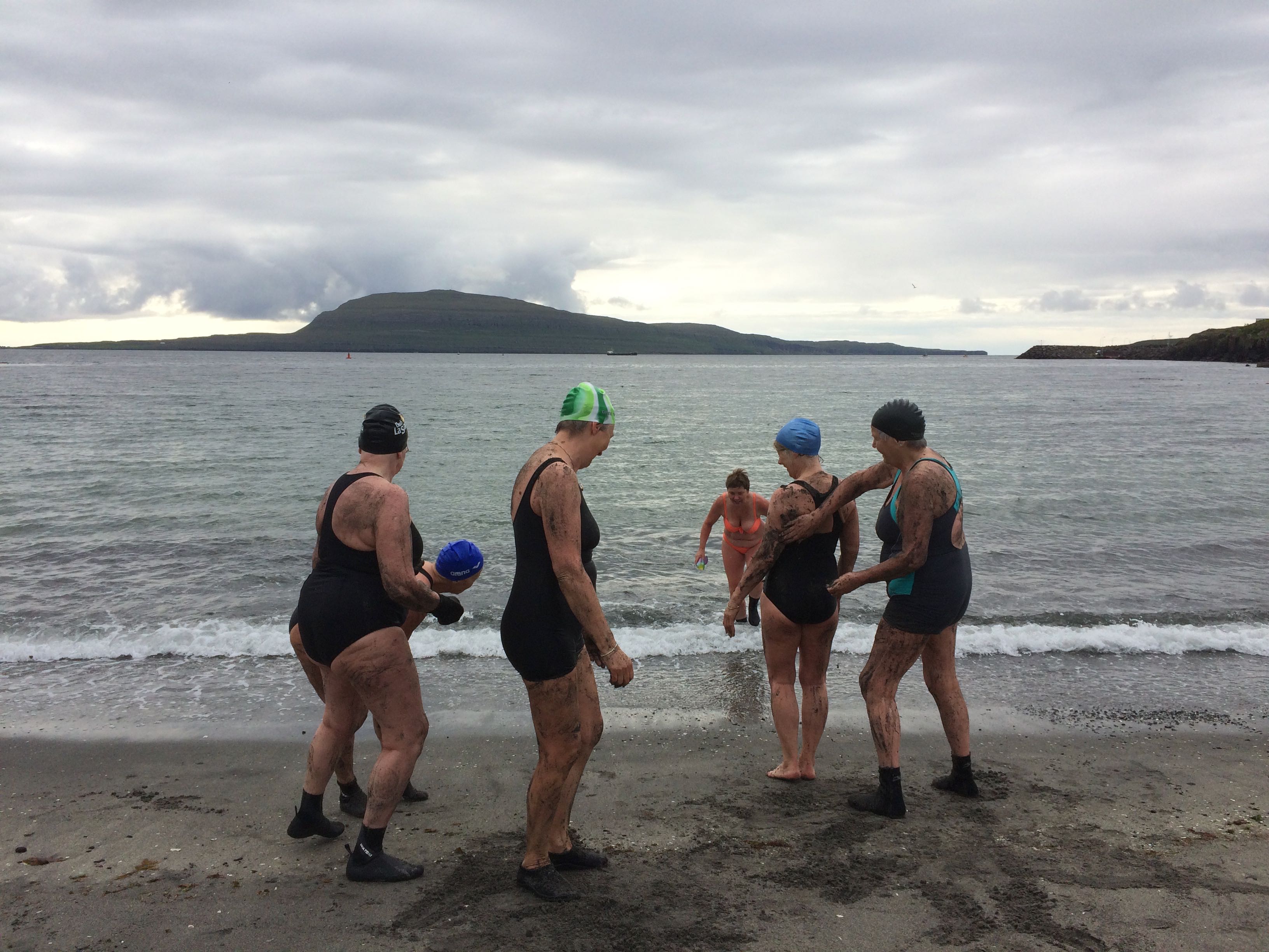 Women swimming at a beach in the Faroe Islands.