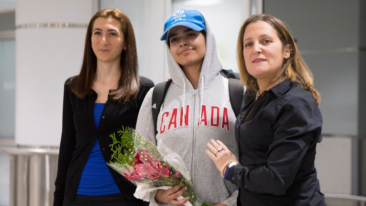 Rahaf Mohammed al-Qunun stands with Canadian Foreign Minister Chrystia Freeland (right) as she arrives at Toronto Pearson International Airport.