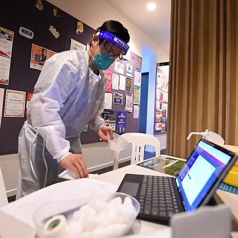 Healthcare worker Suman Rai sanitises a workspace at a pop-up Covid19 vaccination clinic in Broadmeadows, Melbourne.