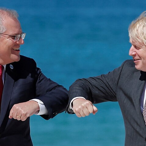 Britain's Prime Minister Boris Johnson (R) greets Australia's Prime Minister Scott Morrison (L)