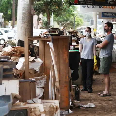 Residents and business owners assess the flood damage in Lismore, NSW. 