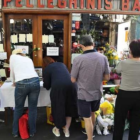 Mourners pay their respects at the workplace of the man killed at Bourke Street