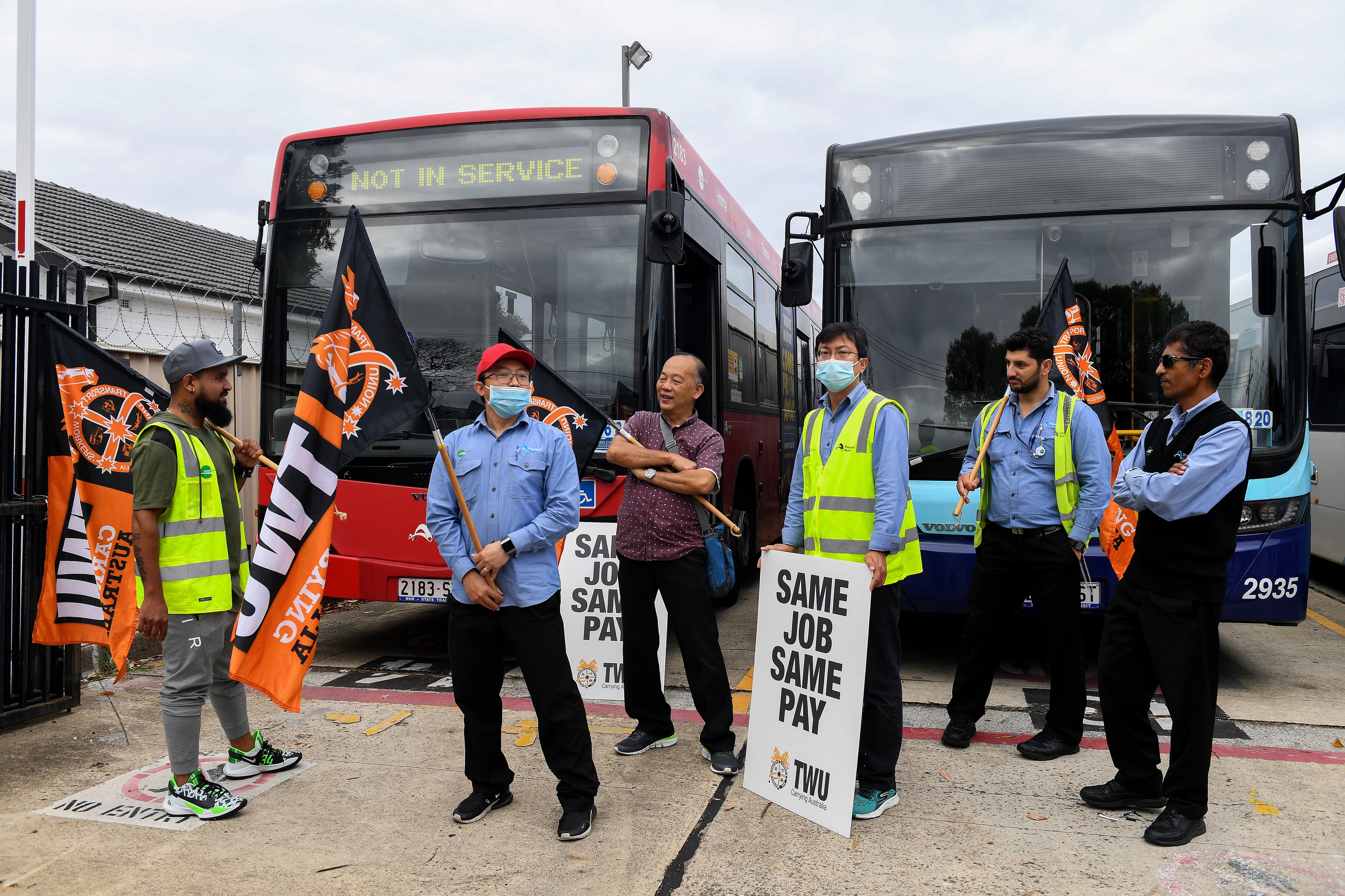 Bus drivers hold placards