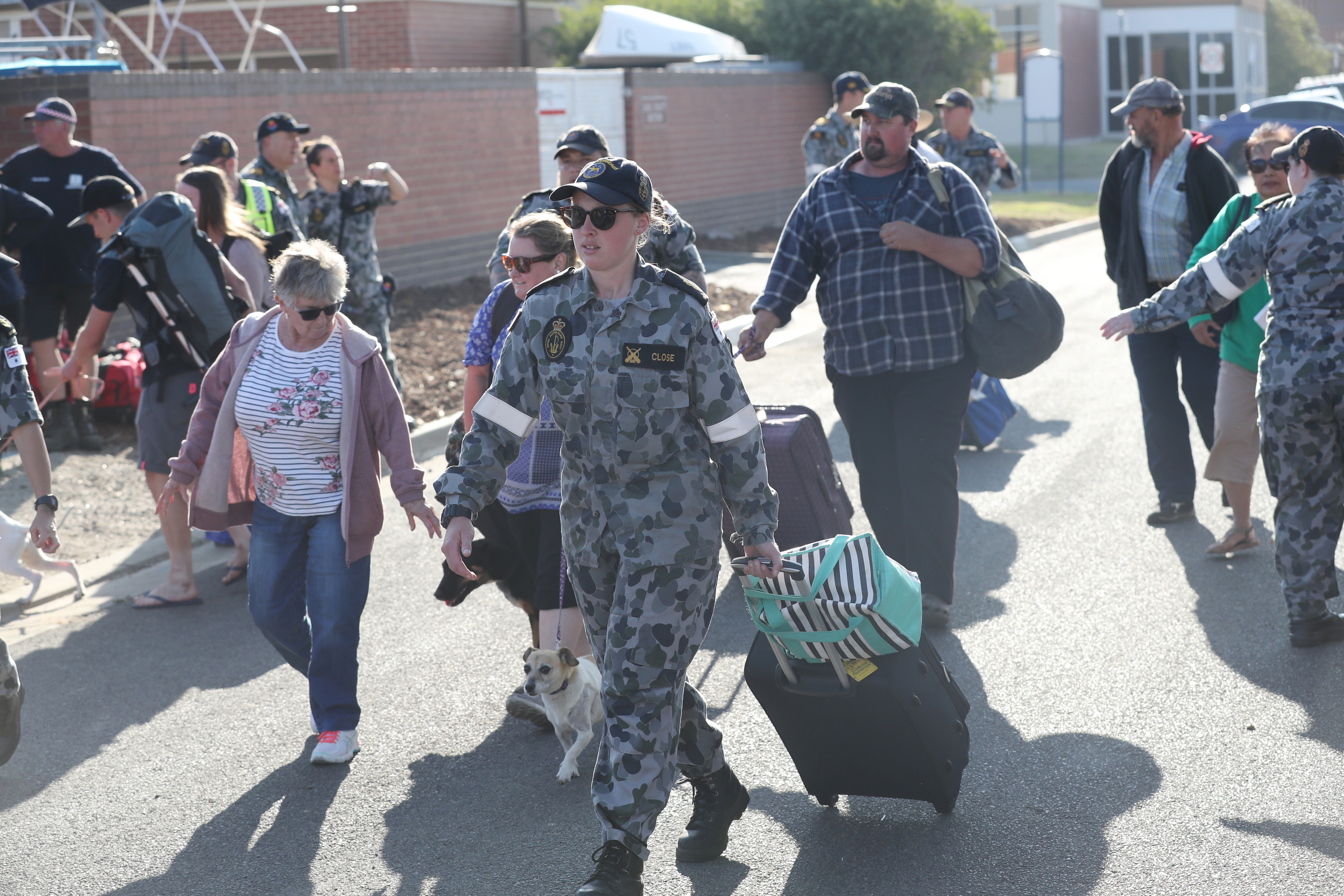 Evacuees from the Victorian town of Mallacoota are escorted to waiting Australian Navy ships.
