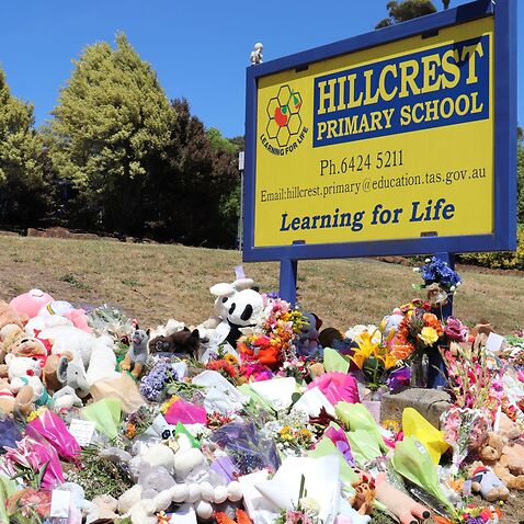 Flowers and tributes are seen outside Hillcrest Primary School in Devonport, Tasmania, Friday, December 17, 2021.