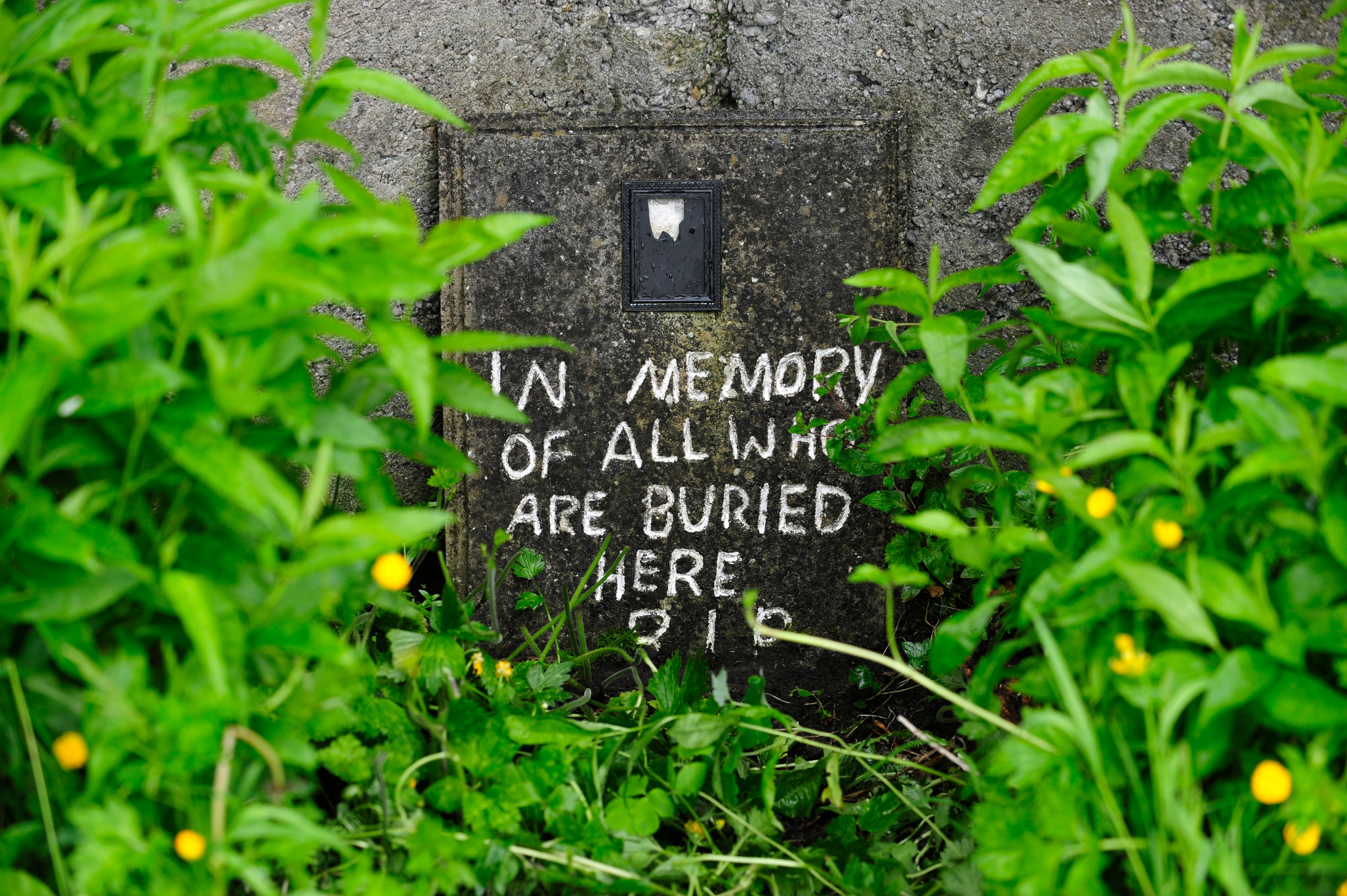 A file photo of a handwritten message painted on the site of a mass grave near the former Mother and Baby home in Tuam, County Galway, Ireland. 