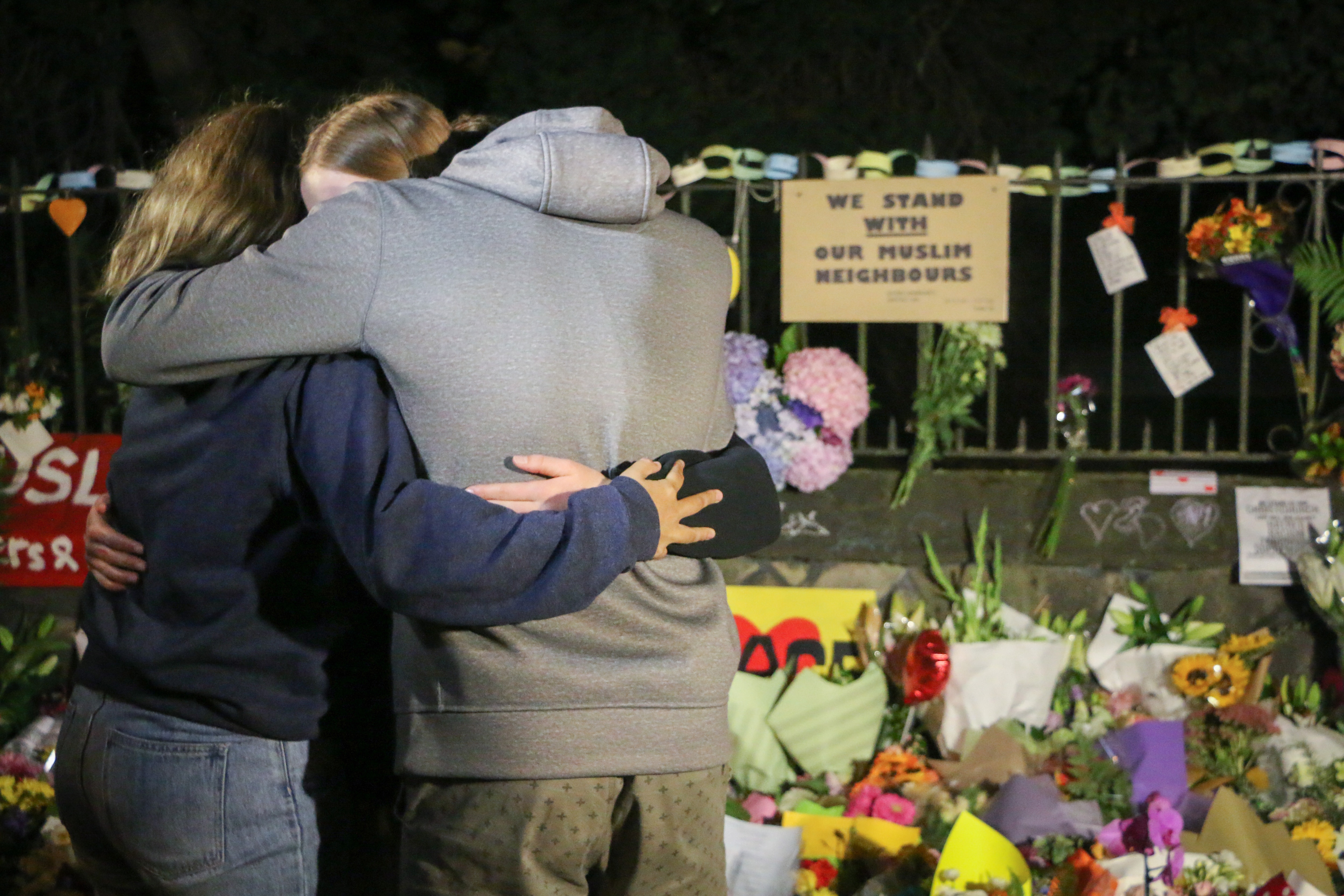 People seen comforting themselves while paying respect to the victims of the Christchurch mosques shooting. 