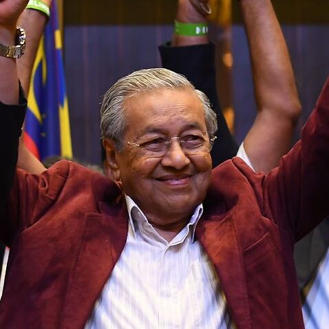Former Malaysian prime minister and opposition candidate Mahathir Mohamad celebrates.