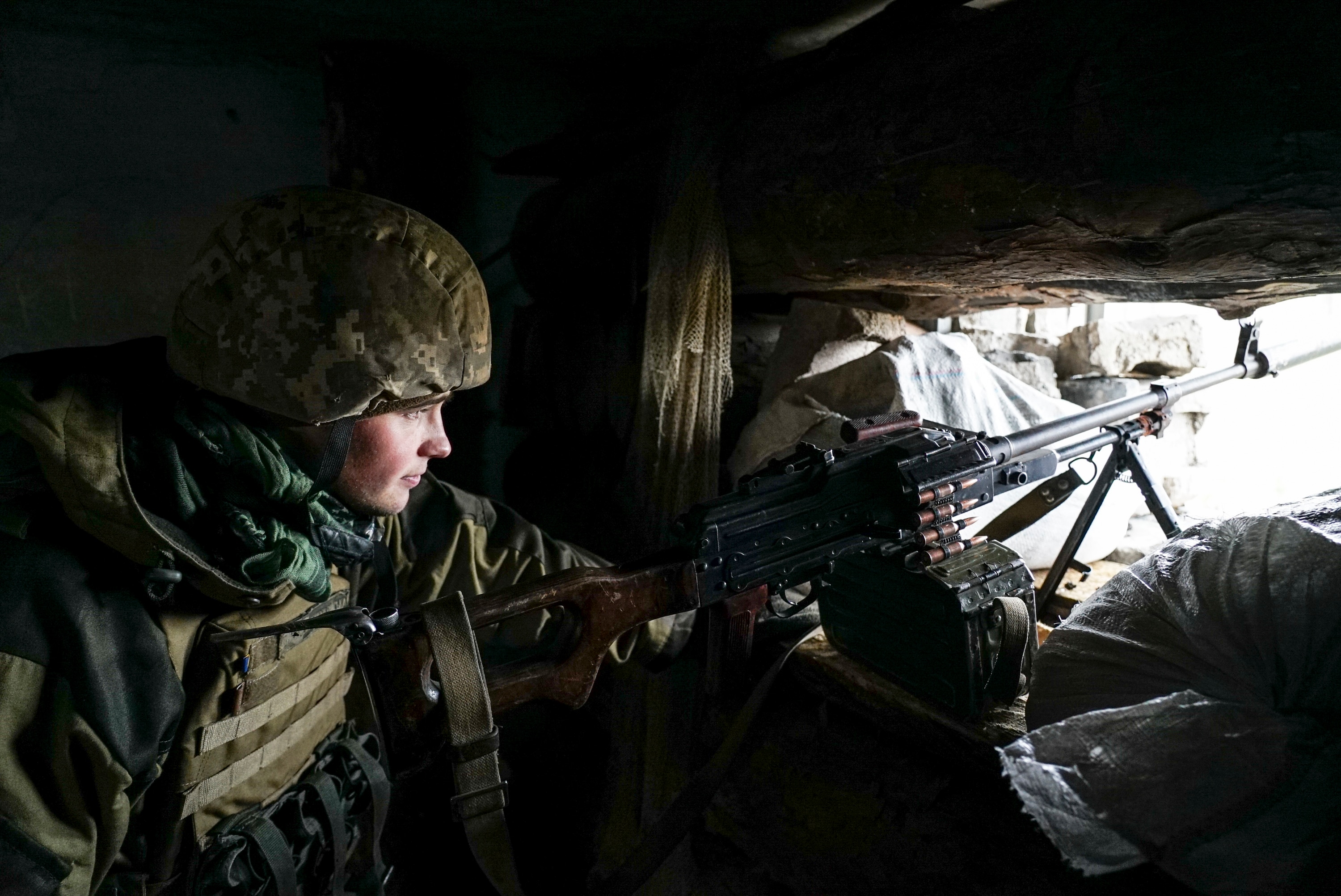A Ukrainian soldier looks from his position near the frontline with Russia-backed separatists in Shyrokyne, eastern Ukraine