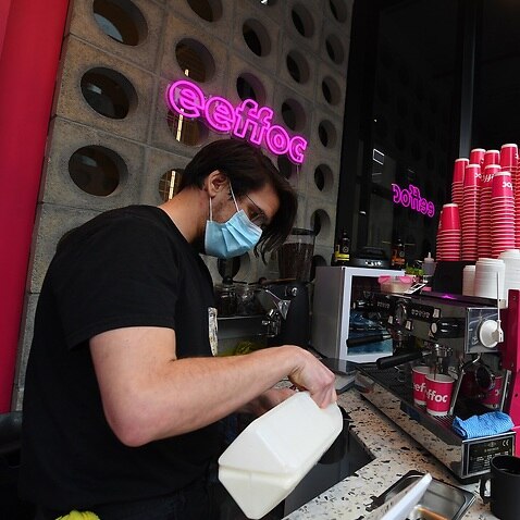 Barista Alex Pallas is seen making a coffee at Eeffoc Cafe in Prahran, Melbourne.