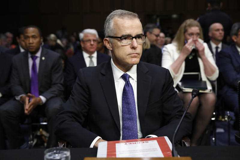 Acting FBI Director Andrew McCabe sits with a folder marked Secret in front of him while testifying on Capitol Hill in Washington