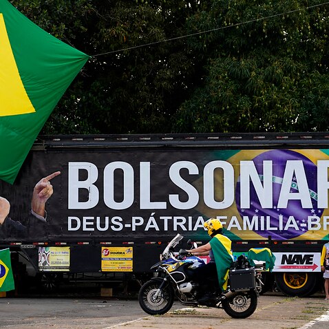 A truck bearing the image of Brazilian President Jair Bolsonaro and the Portuguese words 