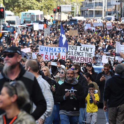 Protesters march along Broadway and George St towards Sydney Town Hall during the ‘World Wide Rally For Freedom’ anti-lockdown rally at Hyde Park in Sydney, Saturday, July 24, 2021. (AAP Image/Mick Tsikas) NO ARCHIVING