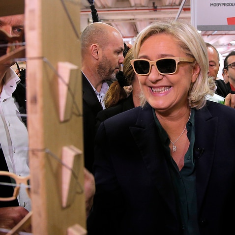 Far-right leader Marine le Pen tries glasses as she visits the 
