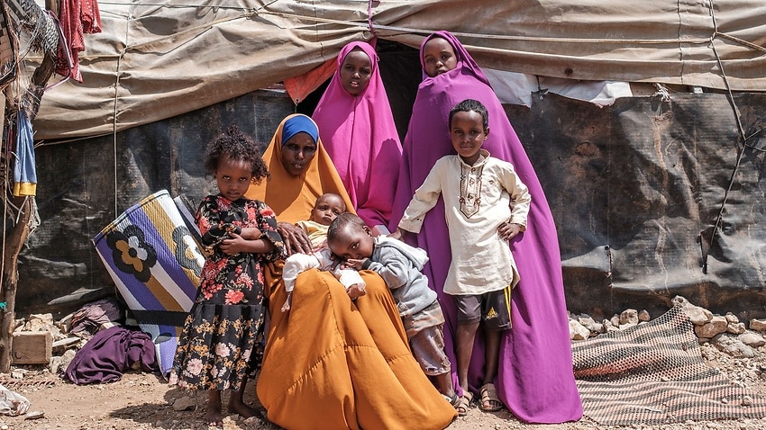 Yurub Abdi Jama sits with her children at their home in an informal settlement of internally displaced people in Somalia.