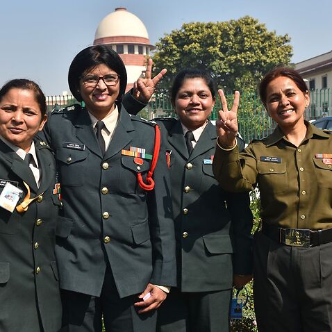 Lt. Col. Seema Singh (2L) and other women army personnel show victory signs after the apex courts decision at Supreme Court on February 17, 2020 in New Delhi.