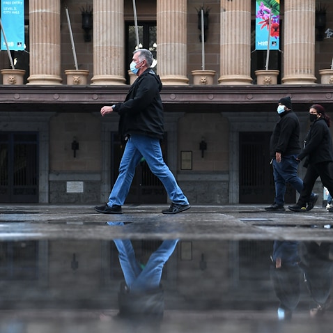 People wearing protective face masks are seen walking through King George Square during lockdown in Brisbane, Thursday, July 1, 2021