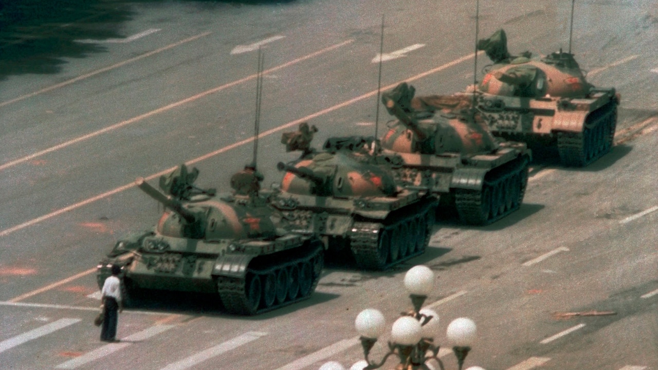 In this iconic 1989 photo, a Chinese man stands alone to block a line of tanks heading east on Beijing's Changan towards Tiananmen Square. In this iconic 1989 photo, a Chinese man stands alone to block a line of tanks heading east on Beijing's Changan Blvd. in Tiananmen Square.