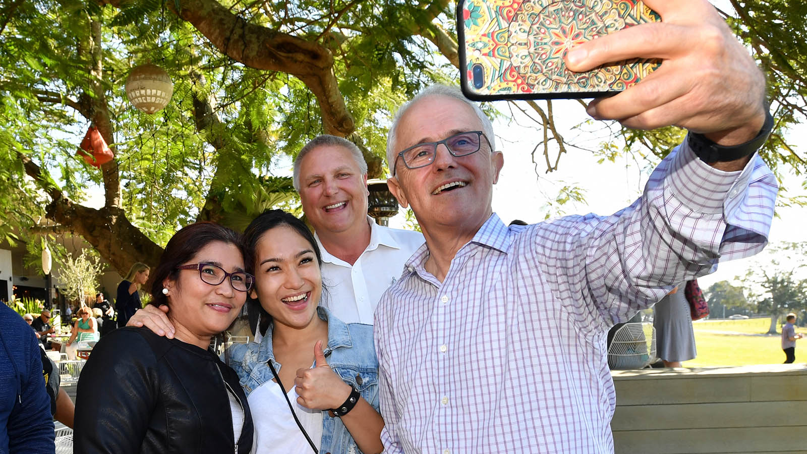 Malcolm Turnbull and LNP candidate for Longman Trevor Ruthenberg pose for a selfie with locals. 