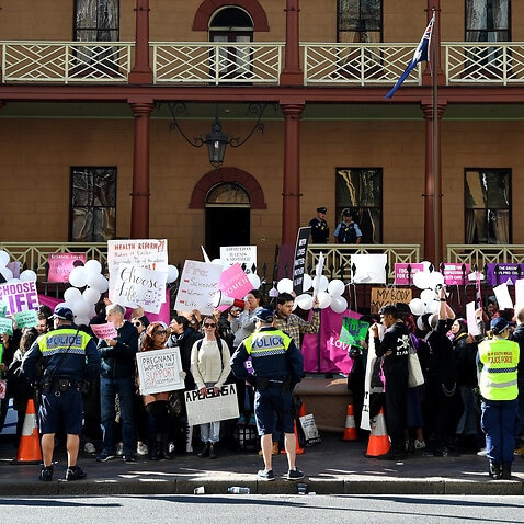 Opposing groups protest outside the New South Wales parliament as abortion legislation is debated.