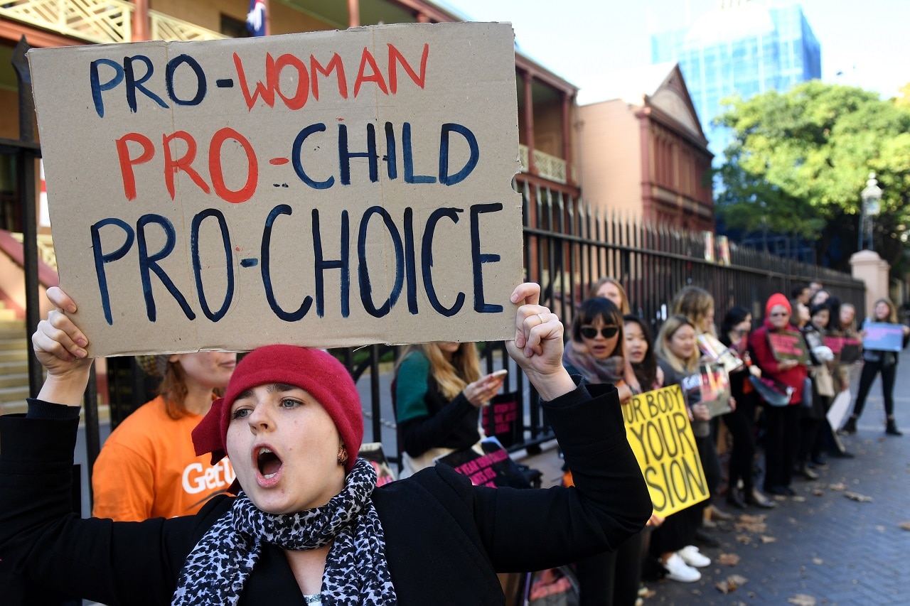 Protesters gather outside of the NSW State Parliament urging MPs to decriminalise abortion.
