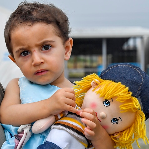 A two-year old Syrian refugee girl at the border between North Macedonia and Greece, near the southern city of Gevgelija, Republic of North Macedonia.
