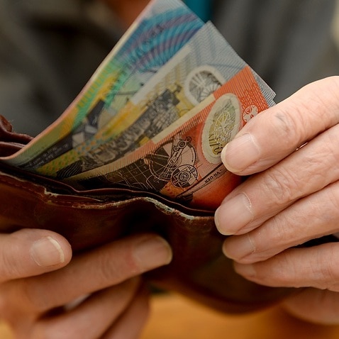 Money is taken out of a wallet Canberra, April 8, 2014. Aged pensions are expected to be hit in the upcoming 2014 budget. (AAP Image/Alan Porritt) NO ARCHIVING