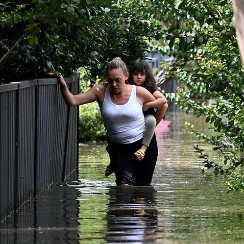 Walking through flood waters in New South Wales.