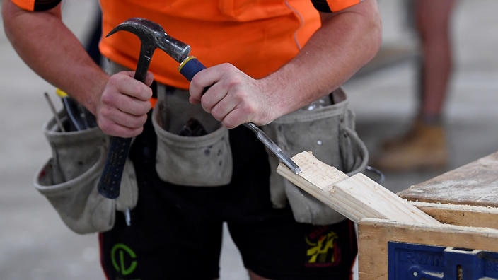 A carpenter is seen working at the Canberra Institute of Technology centre in Canberra.