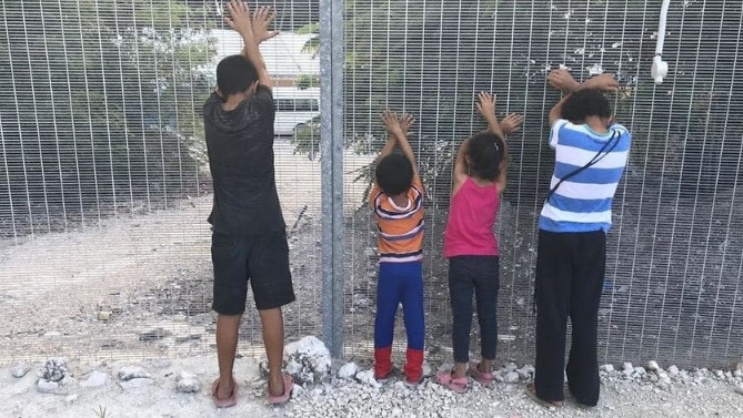 Refugee children play a game on Nauru. 