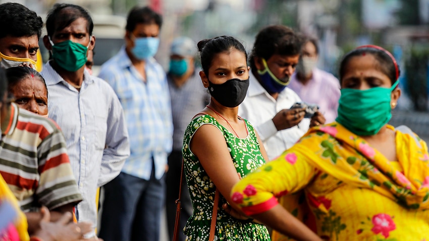 Commuters with face mask to prevent spreading coronavirus wait for but to travel to their destination in Kolkata, India.