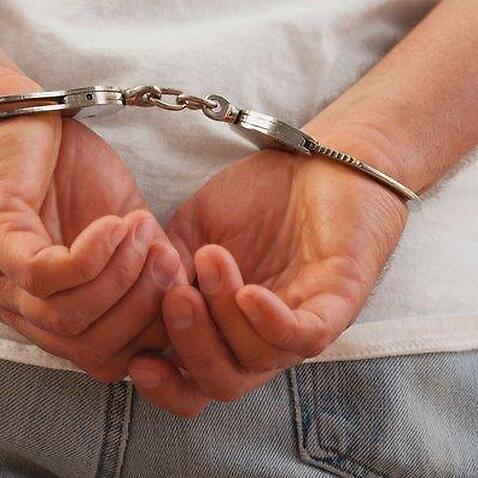 Hands in handcuffs, close-up