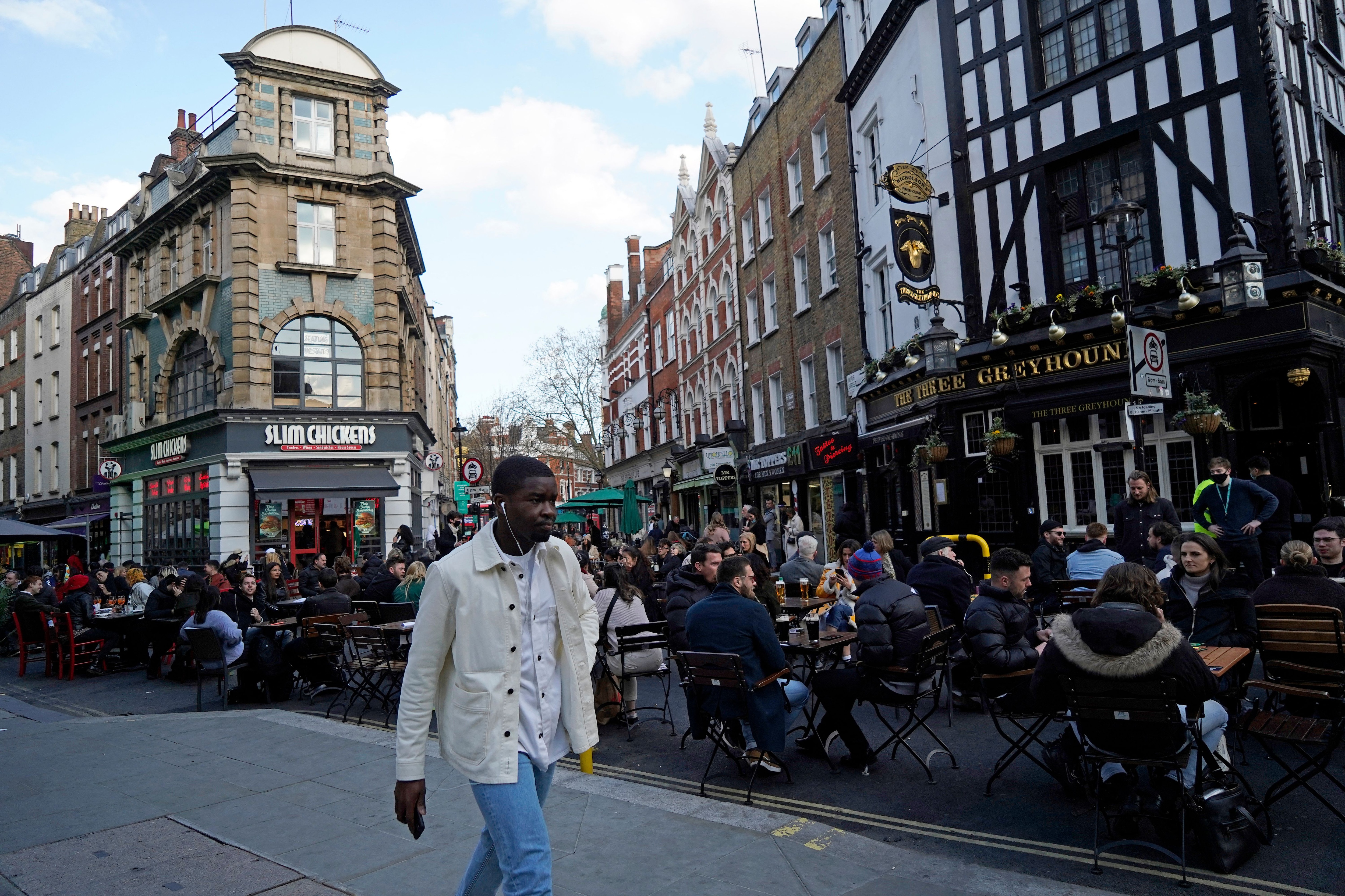 People drink in the street in the Soho area of London, on 16 April, 2021 following step two of the government's roadmap out of England's third lockdown. 