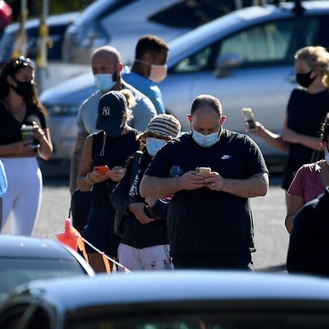 People queue for a COVID-19 PCR test at the Rose Bay drive-through Laverty Pathology clinic, in Sydney, Thursday, December 30, 2021 