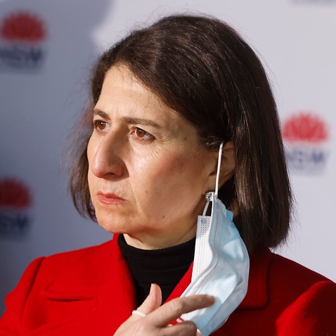 NSW Premier Gladys Berejiklian adjusts her mask during a press conference in Sydney.
