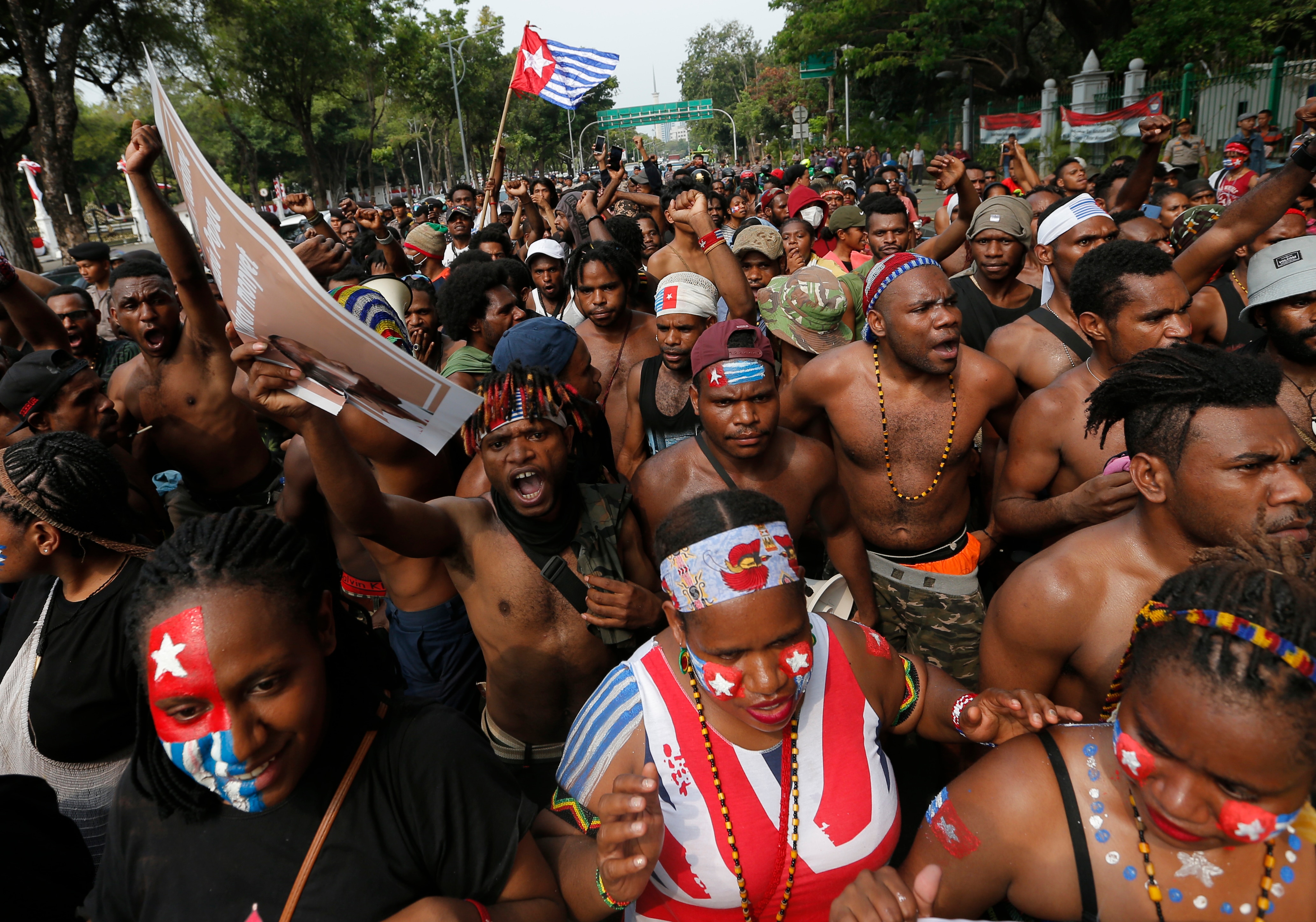 Papuan students shout slogans during a rally near the presidential palace in Jakarta, Indonesia, Wednesday, Aug. 28, 2019.