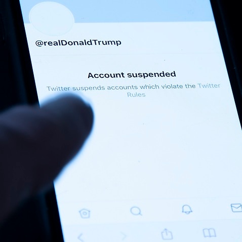President Donald Trump's suspended Twitter account is seen on a mobile phone