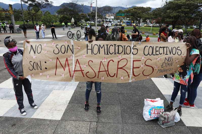  Young people hold a protest banner during a demonstration against the massacres, in Bogota, Colombia.
