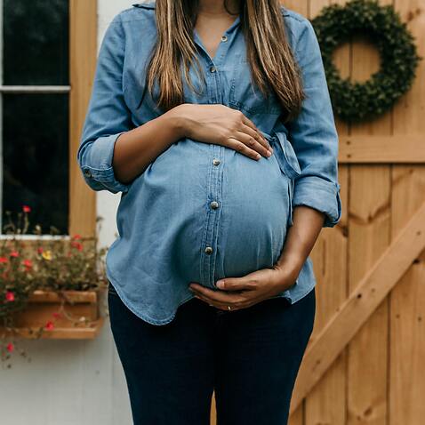 pregnant woman in front of house