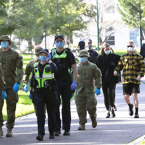 ADF personnel and Victorian police officers are seen patrolling Fitzroy Gardens in Melbourne, Saturday, July 25, 2020.     