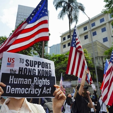 Protesters wave US flags during a protest in Hong Kong.