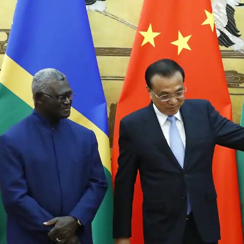 Solomon Islands Prime Minister Manasseh Sogavare (left) and Chinese Premier Li Keqiang attend a signing ceremony in Beijing on 9 October 2019.